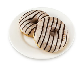 Two donuts with icing on a white plate isolated on white