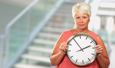 Senior Woman Holding A Clock