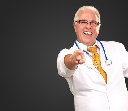 Portrait Of A Senior Doctor Pointing