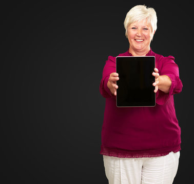 Portrait Of A Senior Woman Holding A Laptop