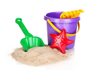 Children's beach toys and sand isolated on white