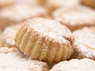 Cupcakes with icing sugar, in a pile, macro