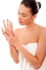 Obraz na płótnie Canvas Fresh and Beautiful brunette woman applying hands cream