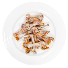 picked chicken bones on plate