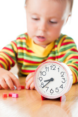 Little cute baby with clock