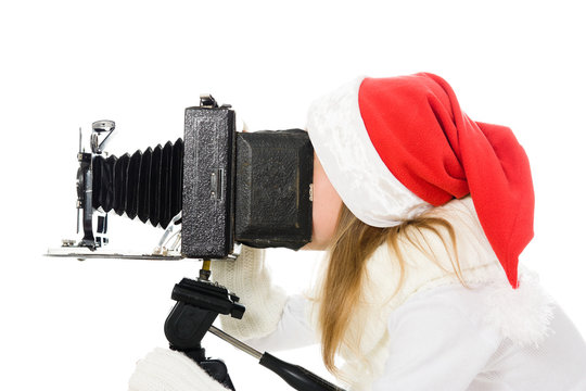 Girl in a Christmas costume with old camera
