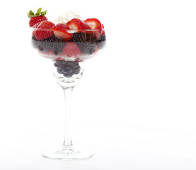 Berries in a glass with whipped cream