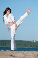 Athletic woman performing a kick