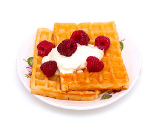 waffles with wheaped cream and raspberrries