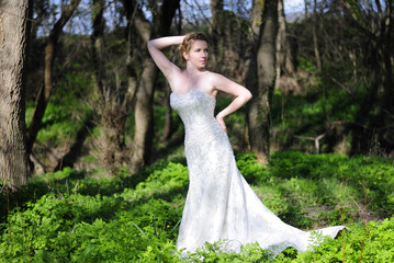 beautiful girl bride in green wood by summer