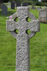 A Celtic Stone Cross Standing in a Graveyard.