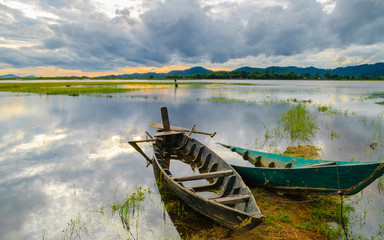 Two wooden boats are anchored, golden hours on the Lak lake, Dak