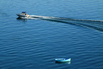 Motor Boat and a Boat on a Lake - obrazy, fototapety, plakaty