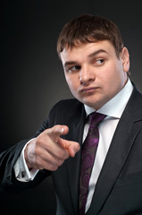 Business man shows his finger at the camera