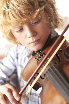 Boy Practicing Violin At Home