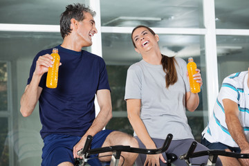 Happy Man And Woman Holding Juice Bottles