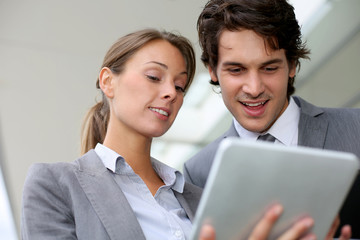 Business partners meeting outside building