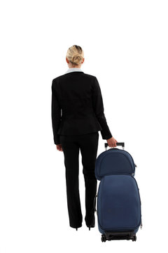 Businesswoman pulling a suitcase