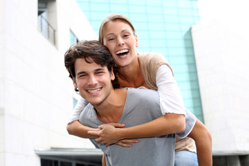 Man giving piggyback ride to girlfriend