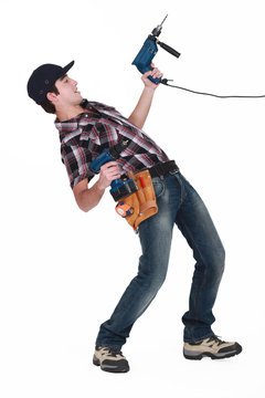 Young Man Pulling A Drill On White Background