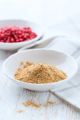 Ground ginger and pink peppercorns in a small bowl