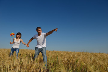 Fototapeta na wymiar happy couple in wheat field
