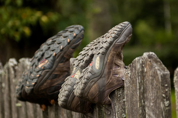 Hiking shoes on a fence