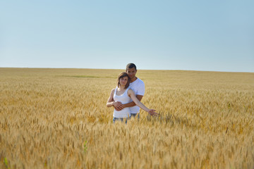 happy couple in wheat field
