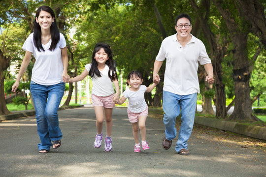 Happy Asian Family Walking On The Road