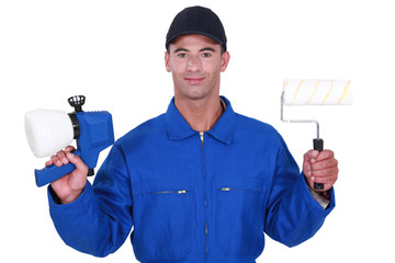 Man with a roller and paint gun