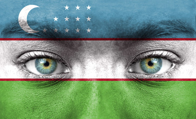 Human face painted with flag of Uzbekistan