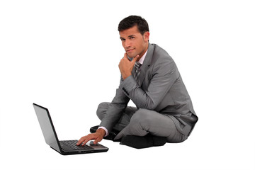 A businessman typing on his laptop.