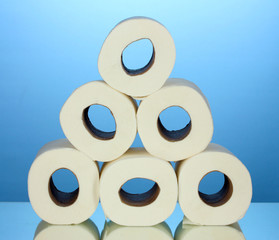 rolls of toilet paper on blue background