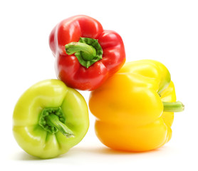 fresh yellow, red and green bell peppers isolated on white
