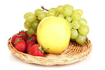 ripe sweet fruits and berries on wicker mat isolated on white
