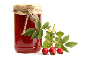 jar with hip roses jam and ripe berries, isolated on white