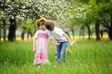 Children kissing in meadow