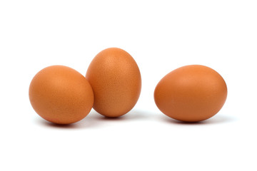 Three eggs closeup isolated on white background.
