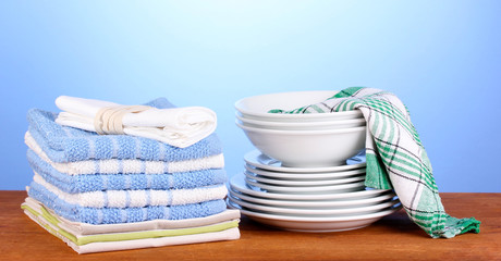 kitchen towels with dishes on blue background close-up