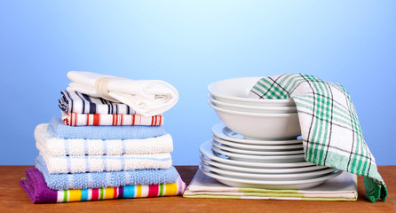 kitchen towels with dishes on blue background close-up