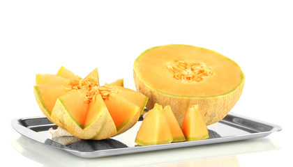 Cut melon on metal tray isolated on white