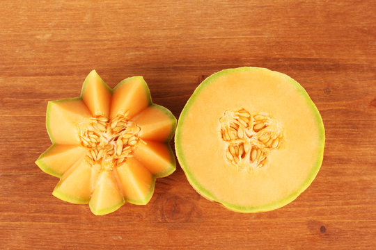 cut melon on wooden background close-up