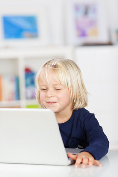 kindergartenkind schaut auf laptop