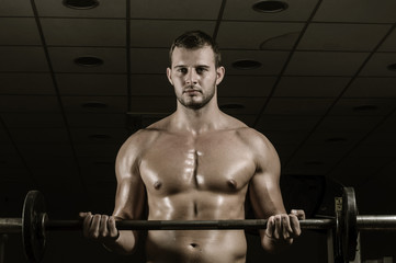 Fototapeta na wymiar Weight lifting in gym