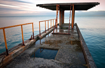 Old pier with red railing. Black Sea coast. Russia, Sochi