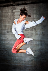 Dancing woman with brown long hair and happy facial expression j