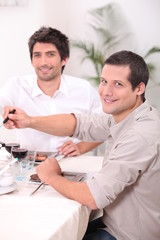 Fototapeta premium two young men having lunch