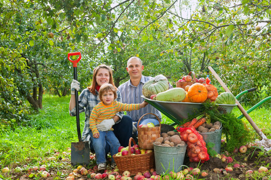 Happy  family with vegetables harvest