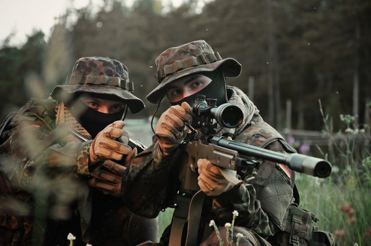 Soldiers snipers attack the enemy from a secured building