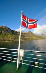 Flag of Norway against the background of a fjord